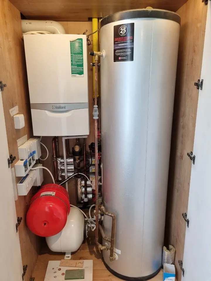 Boiler, hot water cylinder and expansion vessels in a cupboard