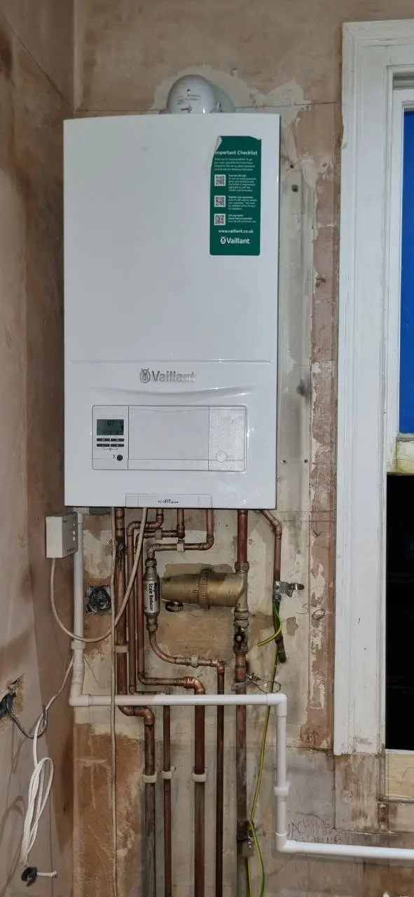 Boiler installed on a wall with copper pipework