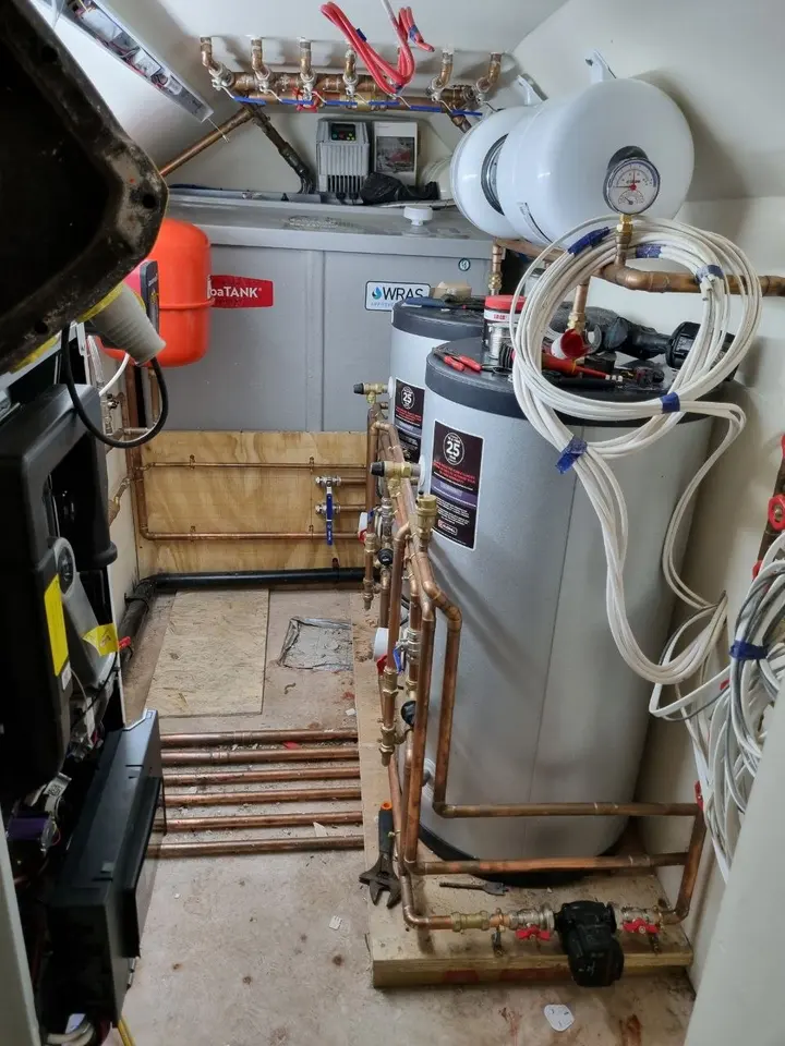 Plant cupboard with a boiler, cylinders and copper pipework