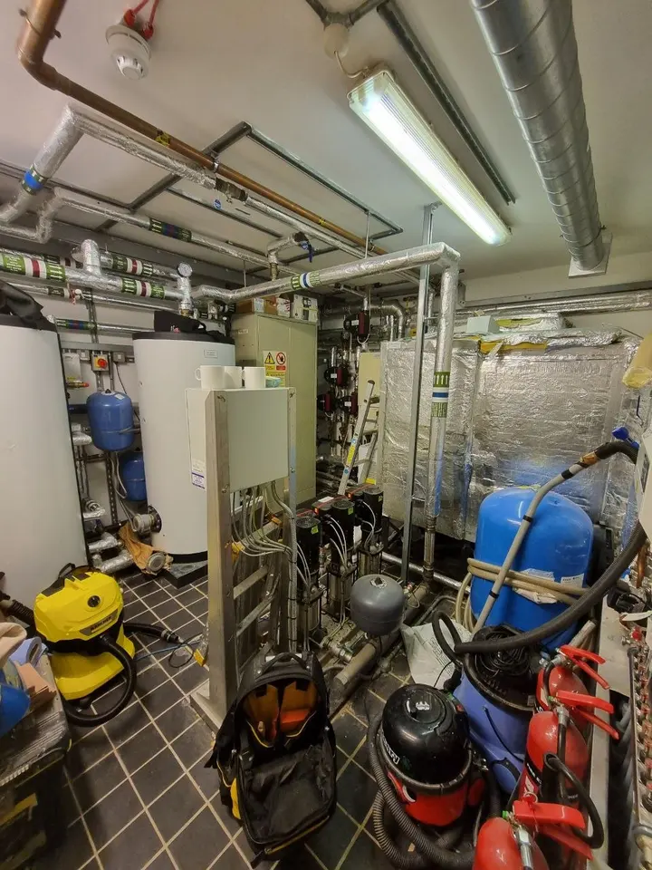 Insulated pipework and pumps in a plant room