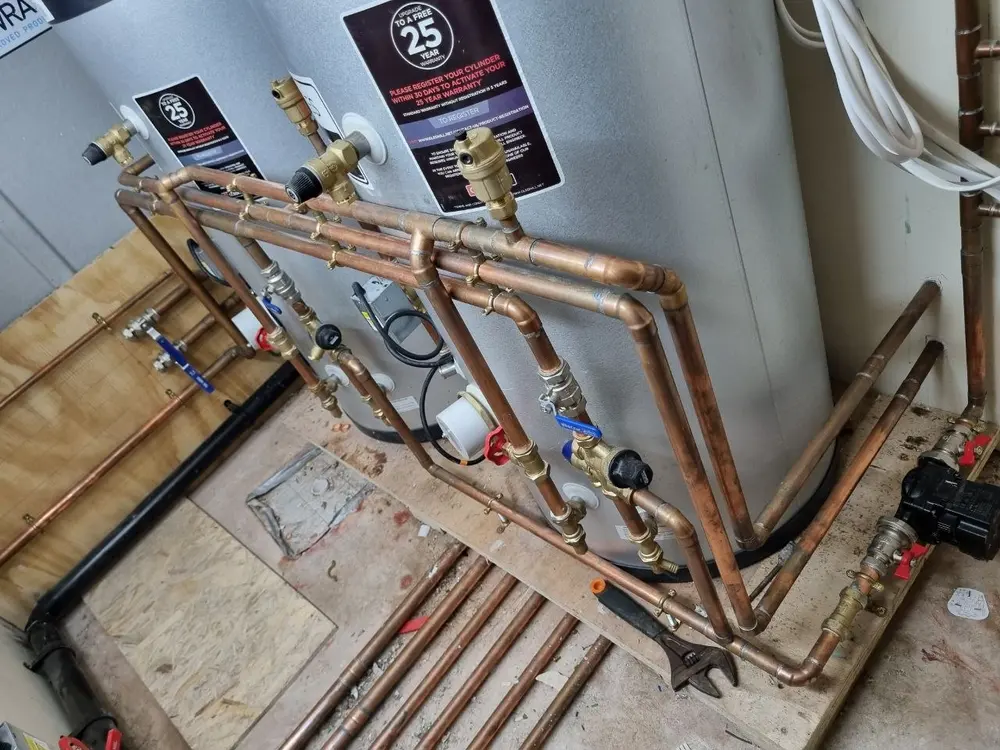Twin hot water cylinders with copper pipework