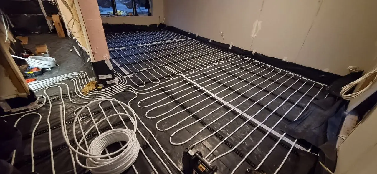 Underfloor heating pipes laid across a room